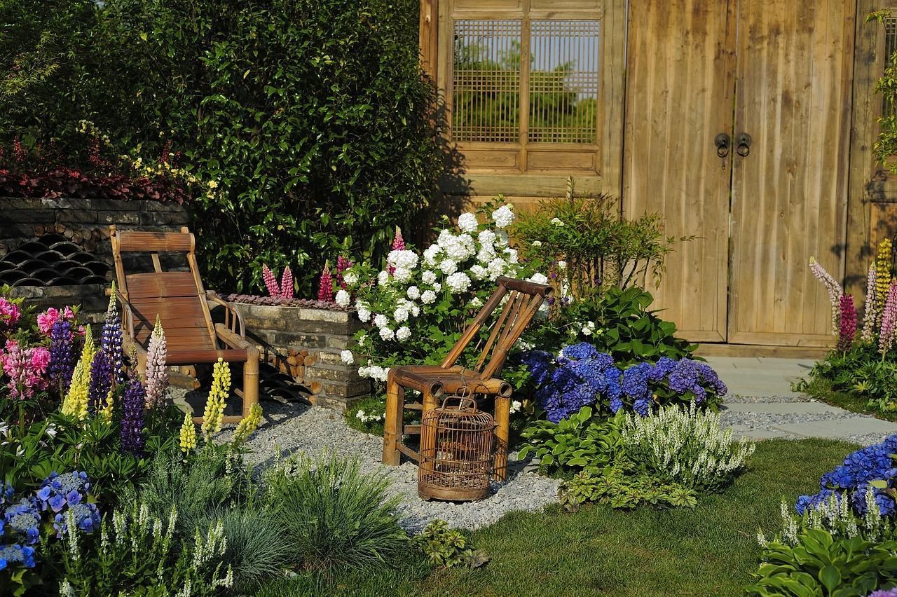 A quaint backyard with greenery and flowers.